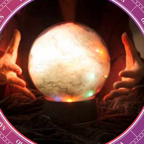 Hands around a glowing crystal ball